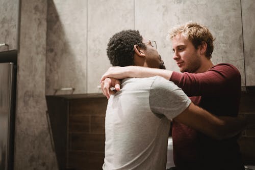 Two Men Embracing Each Other