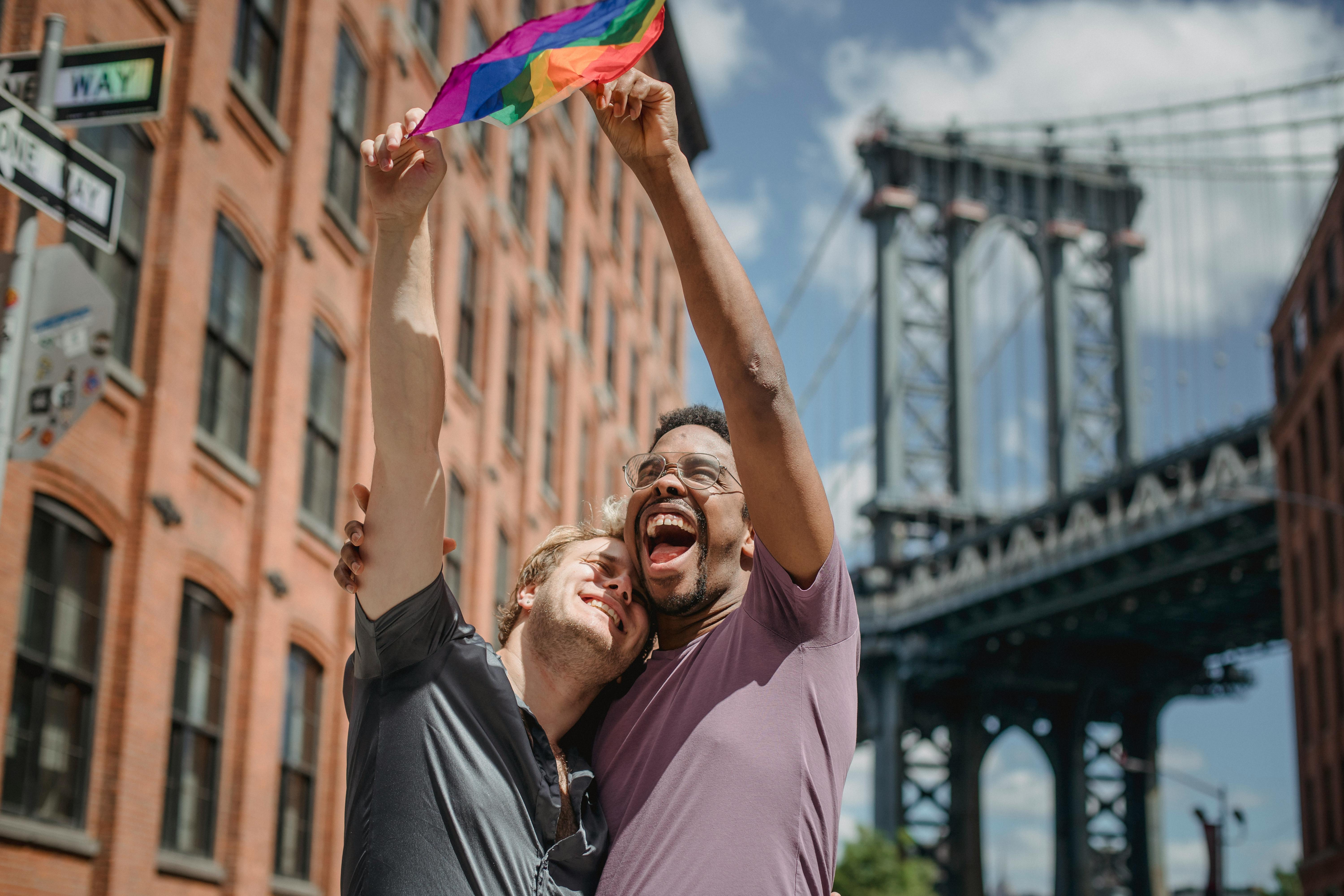 happy couple holding a lgbt flag