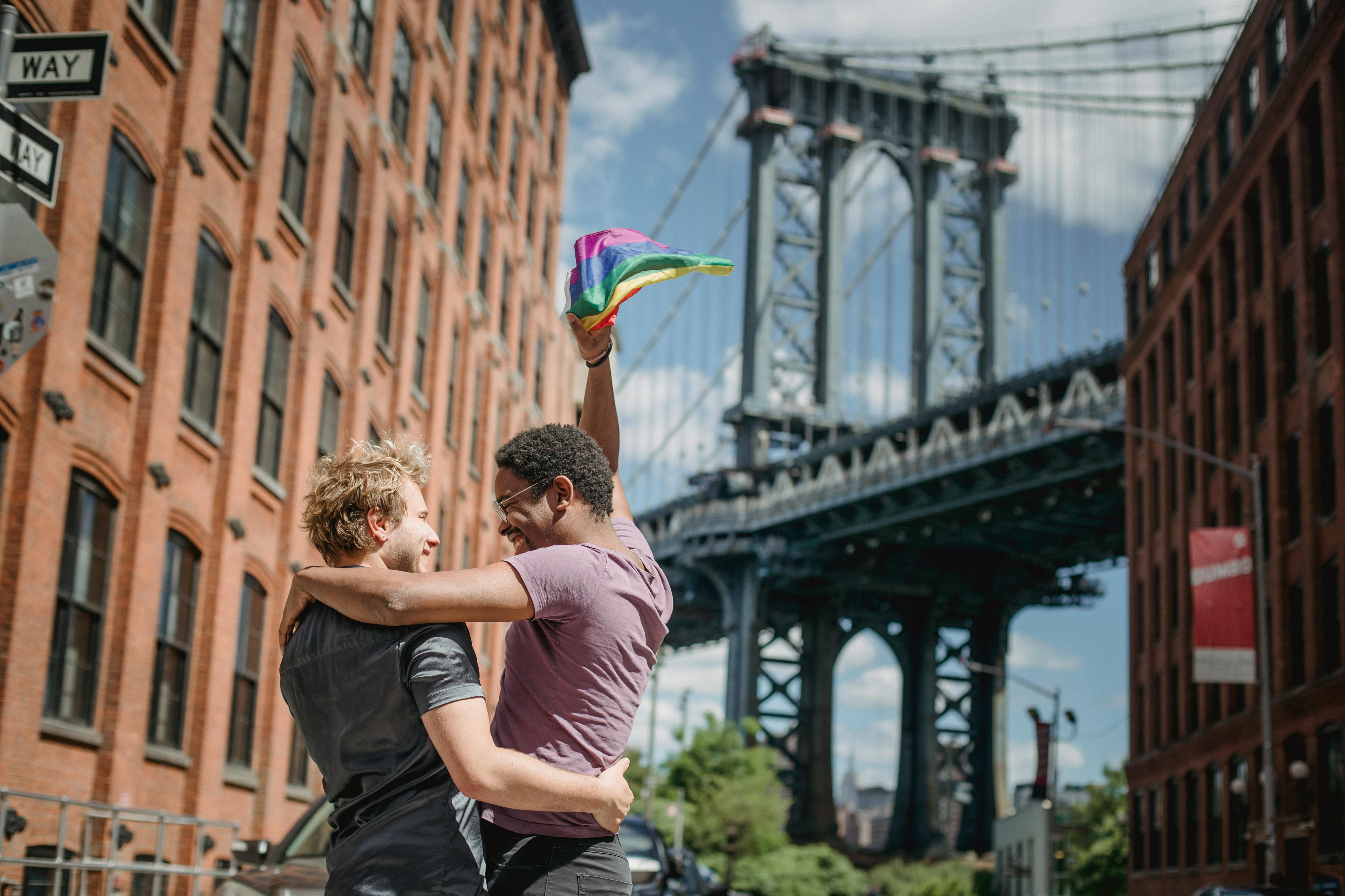 happy couple holding a lgbt flag