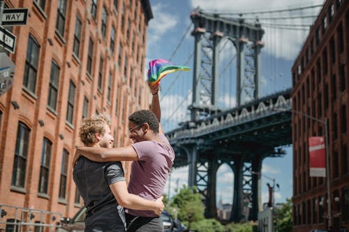 Free Happy Couple Holding a LGBT Flag Stock Photo