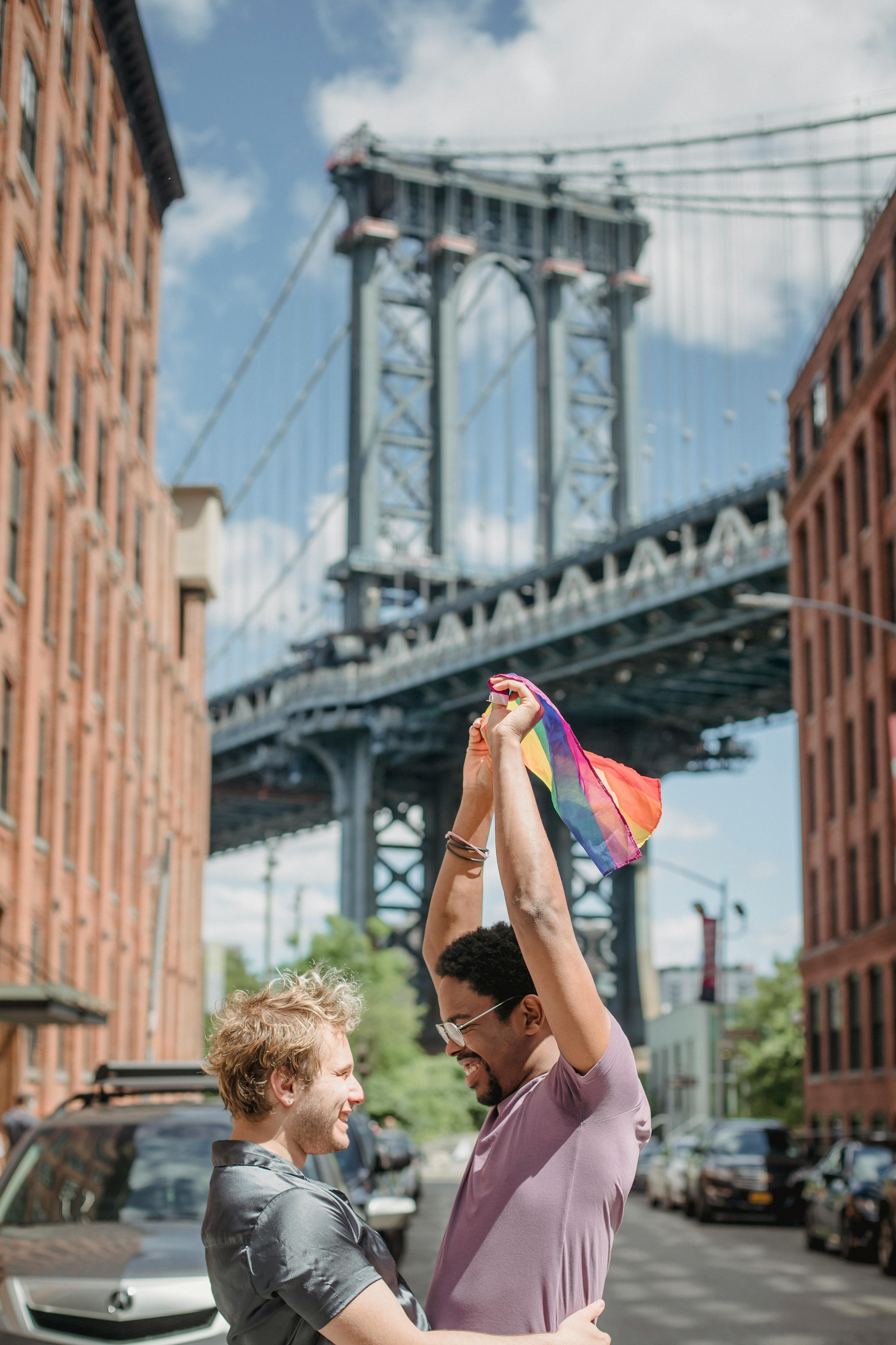 happy couple holding a lgbt flag