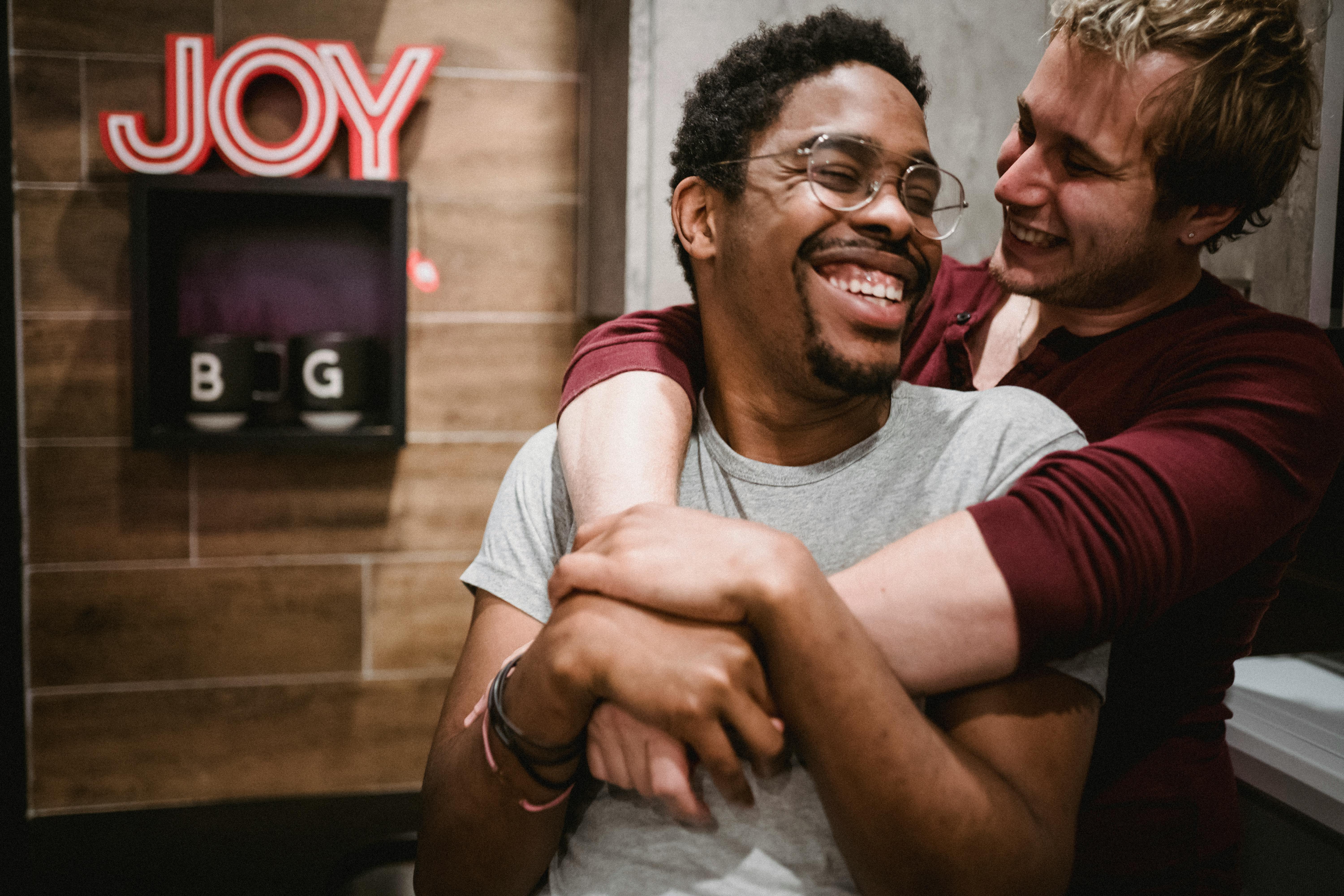 man hugging another man from behind