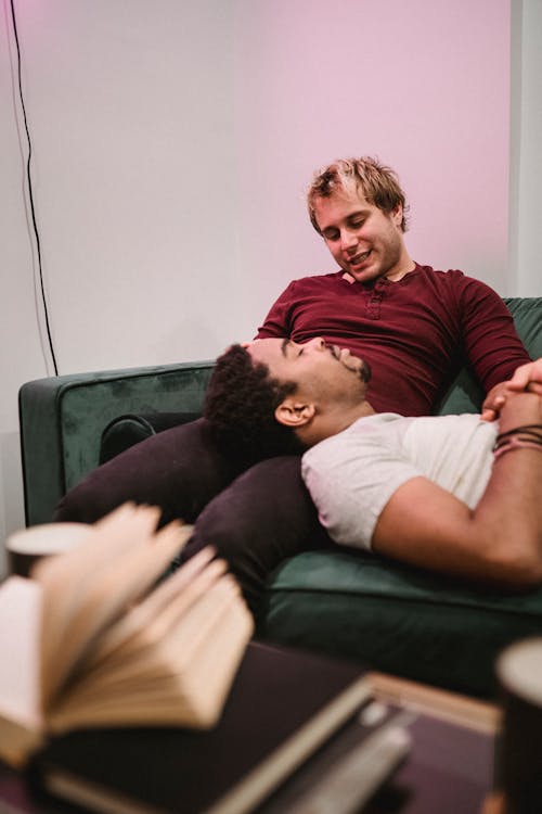 Man Resting his Head on Another Man's Lap