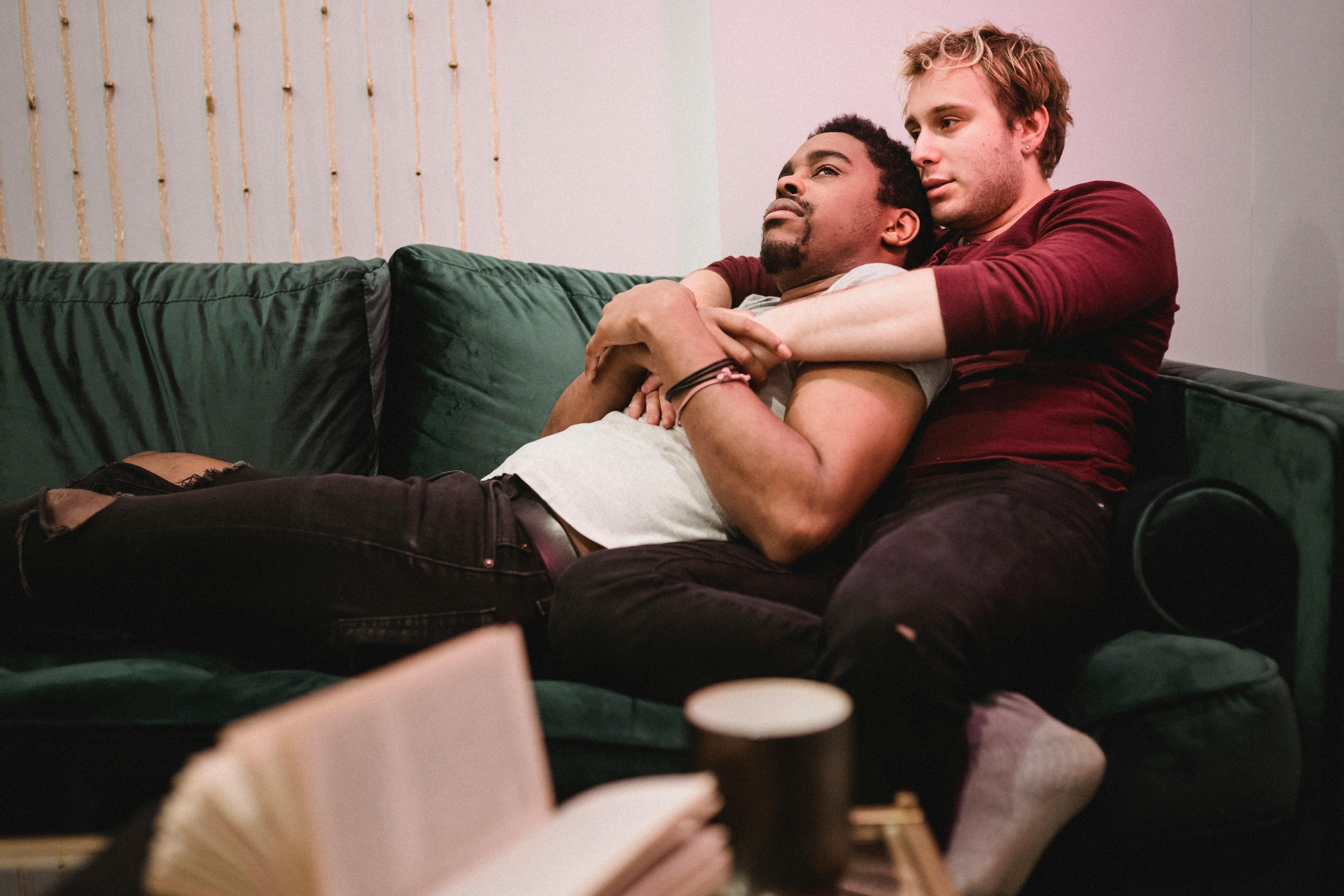 men relaxing together on a couch