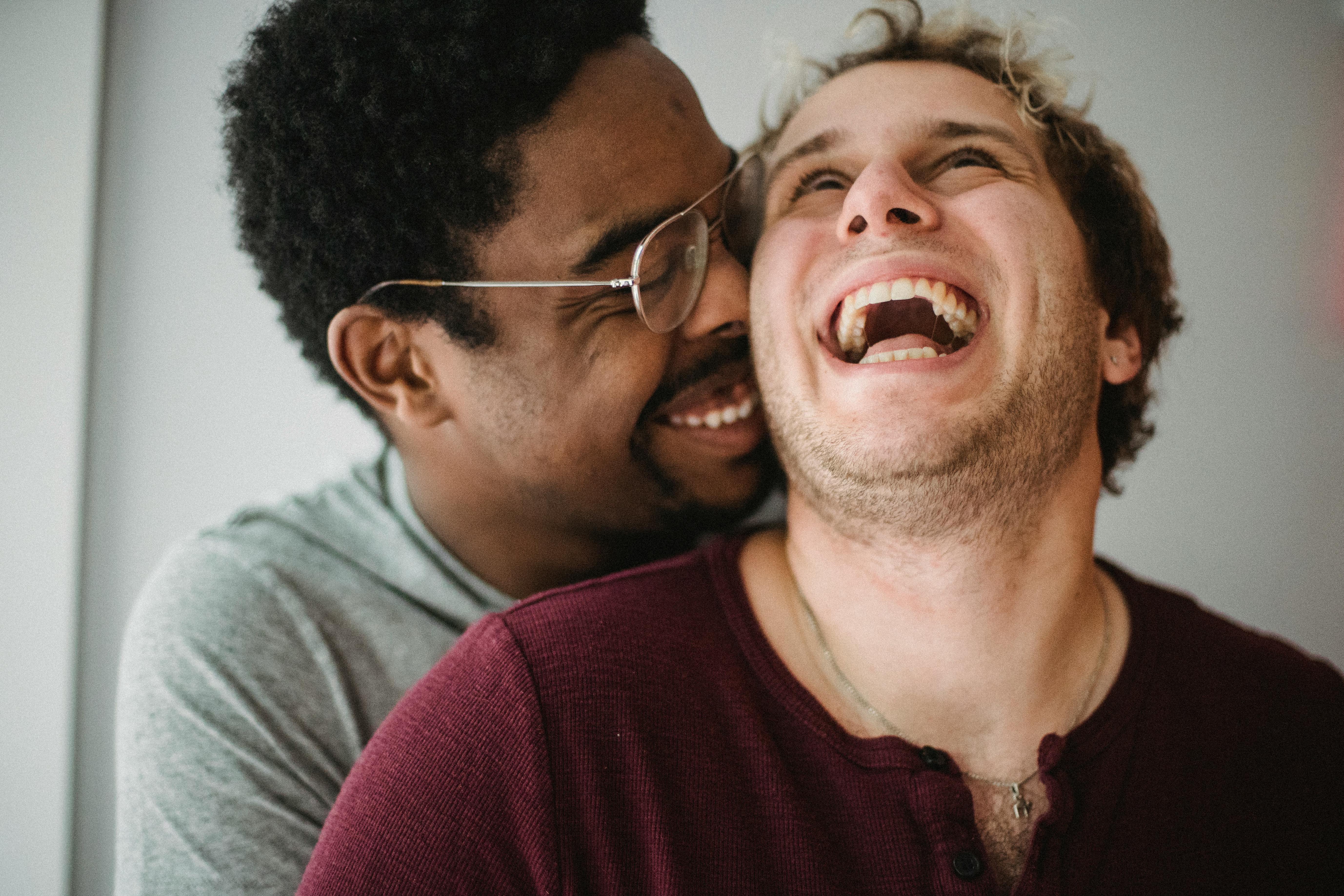 two happy men being affectionate