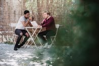 Two Men Sitting with a Newspaper