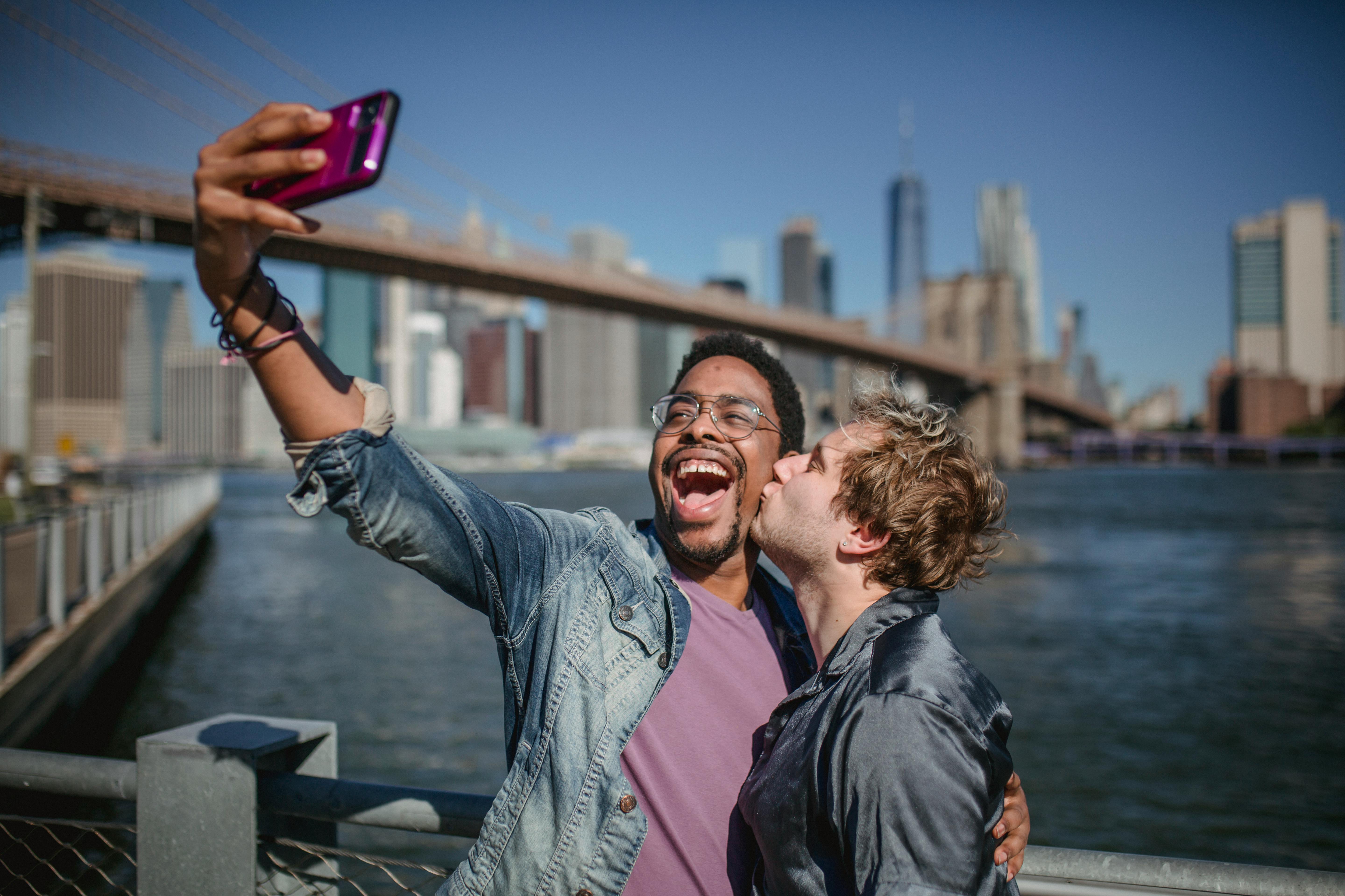 man kissing another man on the cheek