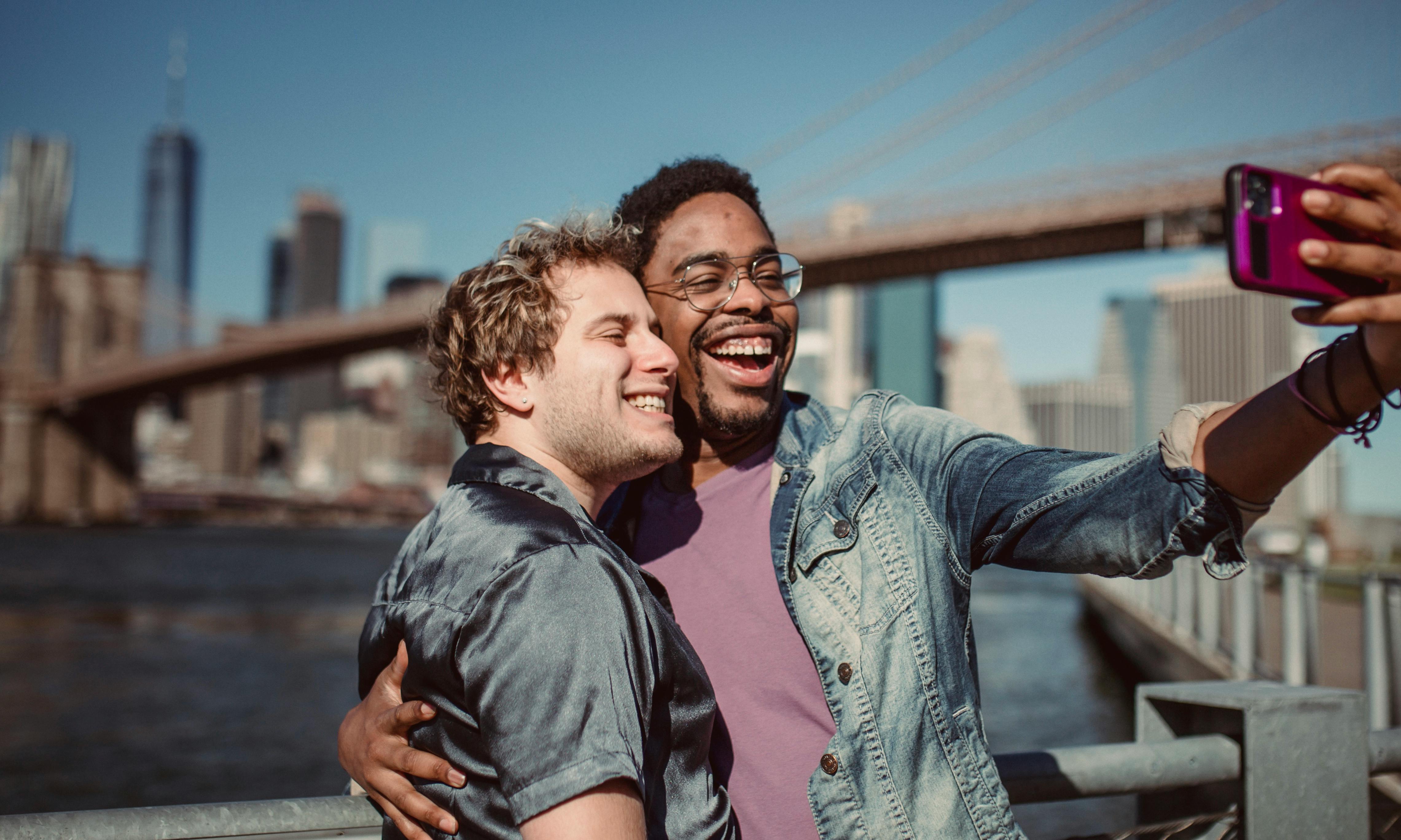 two men smiling and taking a selfie