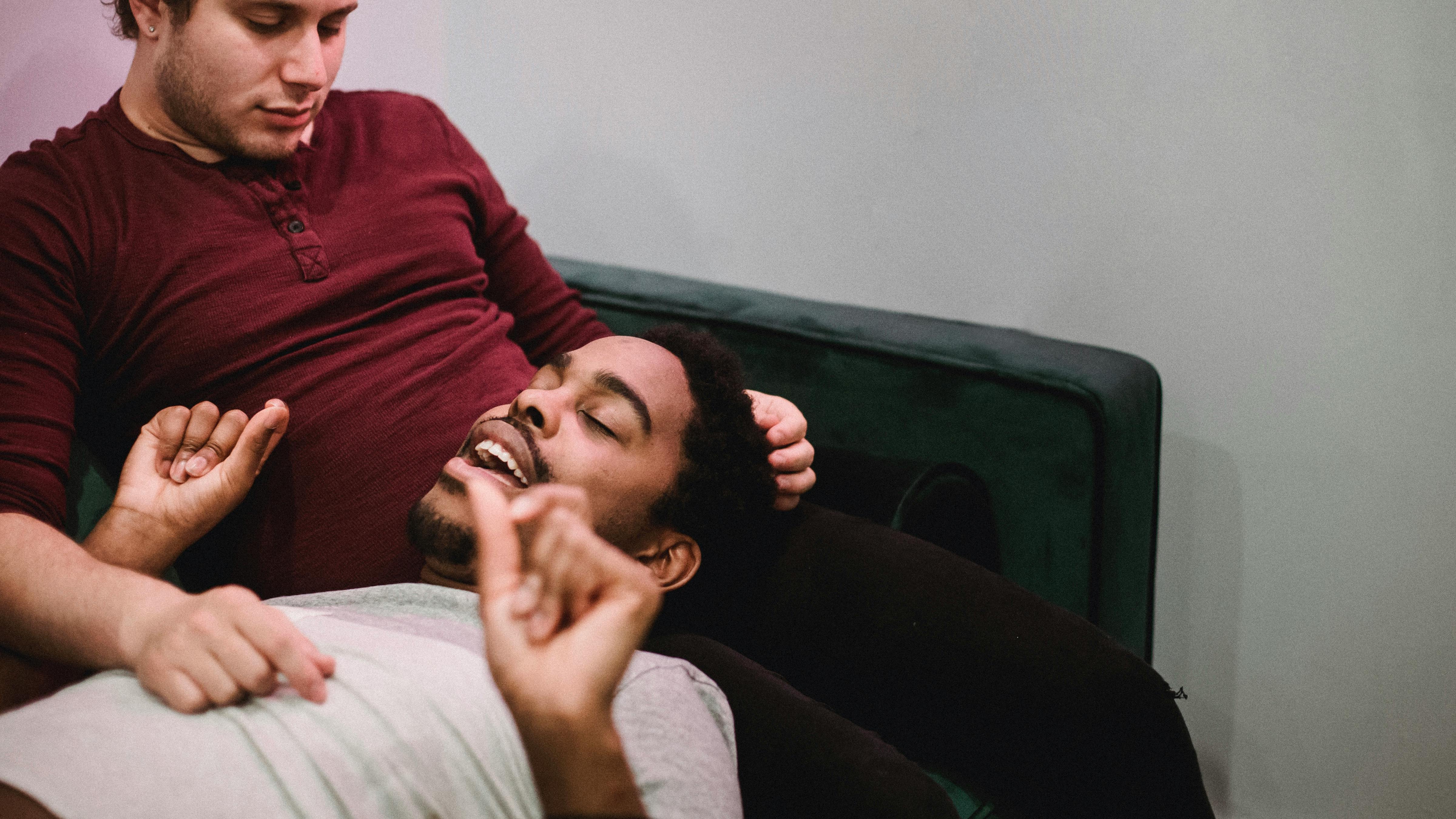 man resting his head on another man s legs