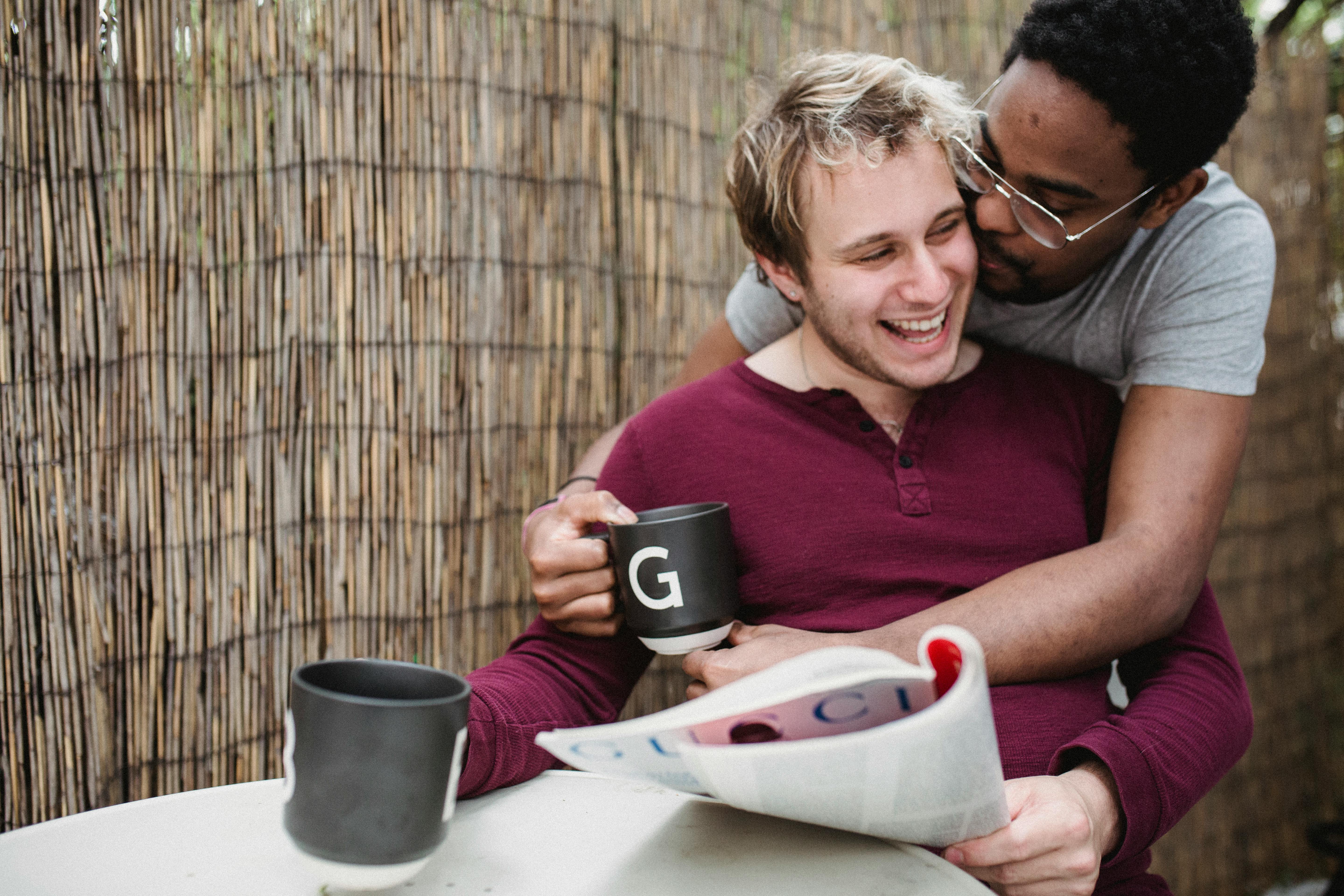 man kissing another man on the cheek