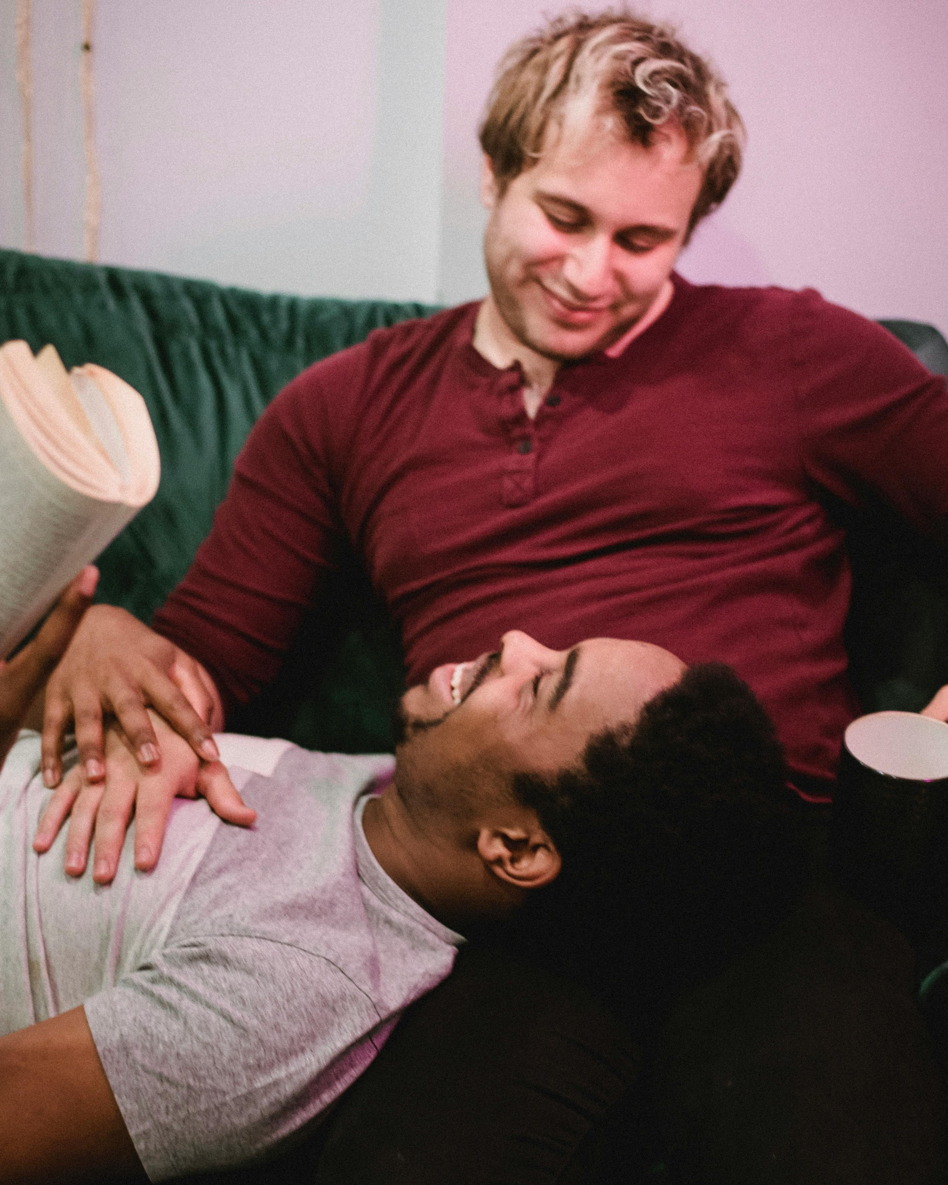 man resting his head on another man s legs