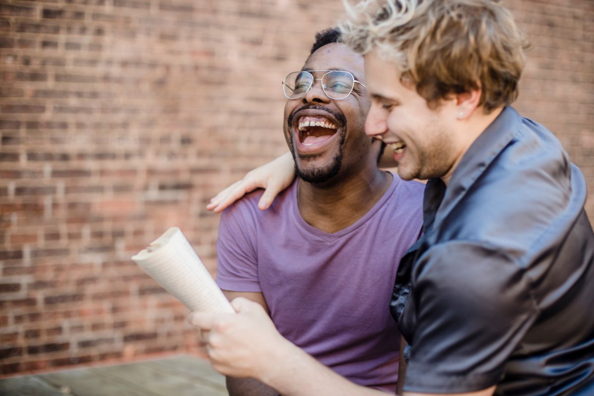Two men laughing during a relaxed conversation