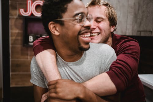Man Hugging Another Man from Behind