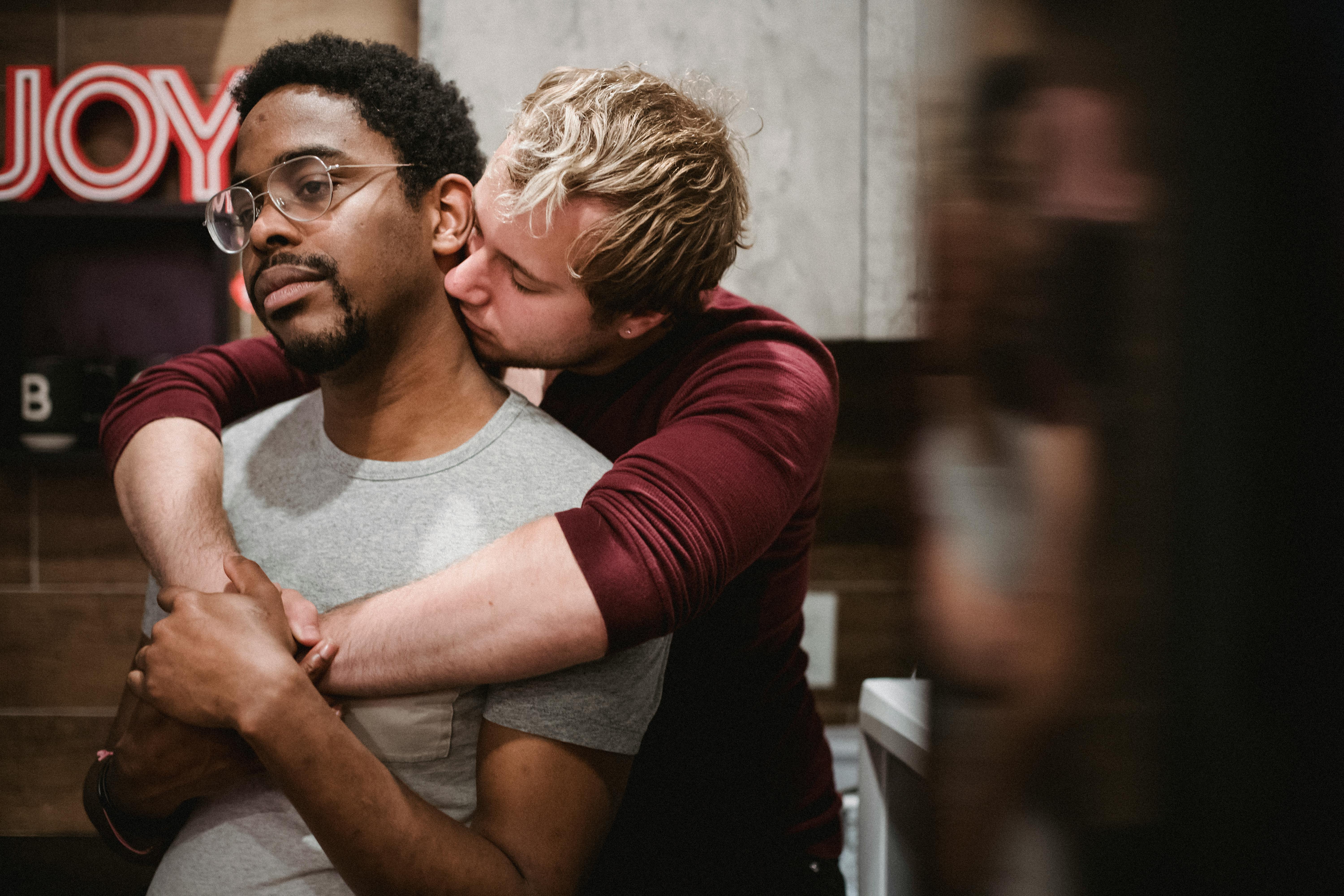 man hugging another man from behind