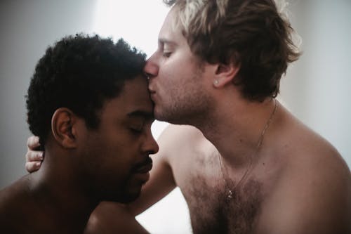 Man Kissing Another Man on the Forehead