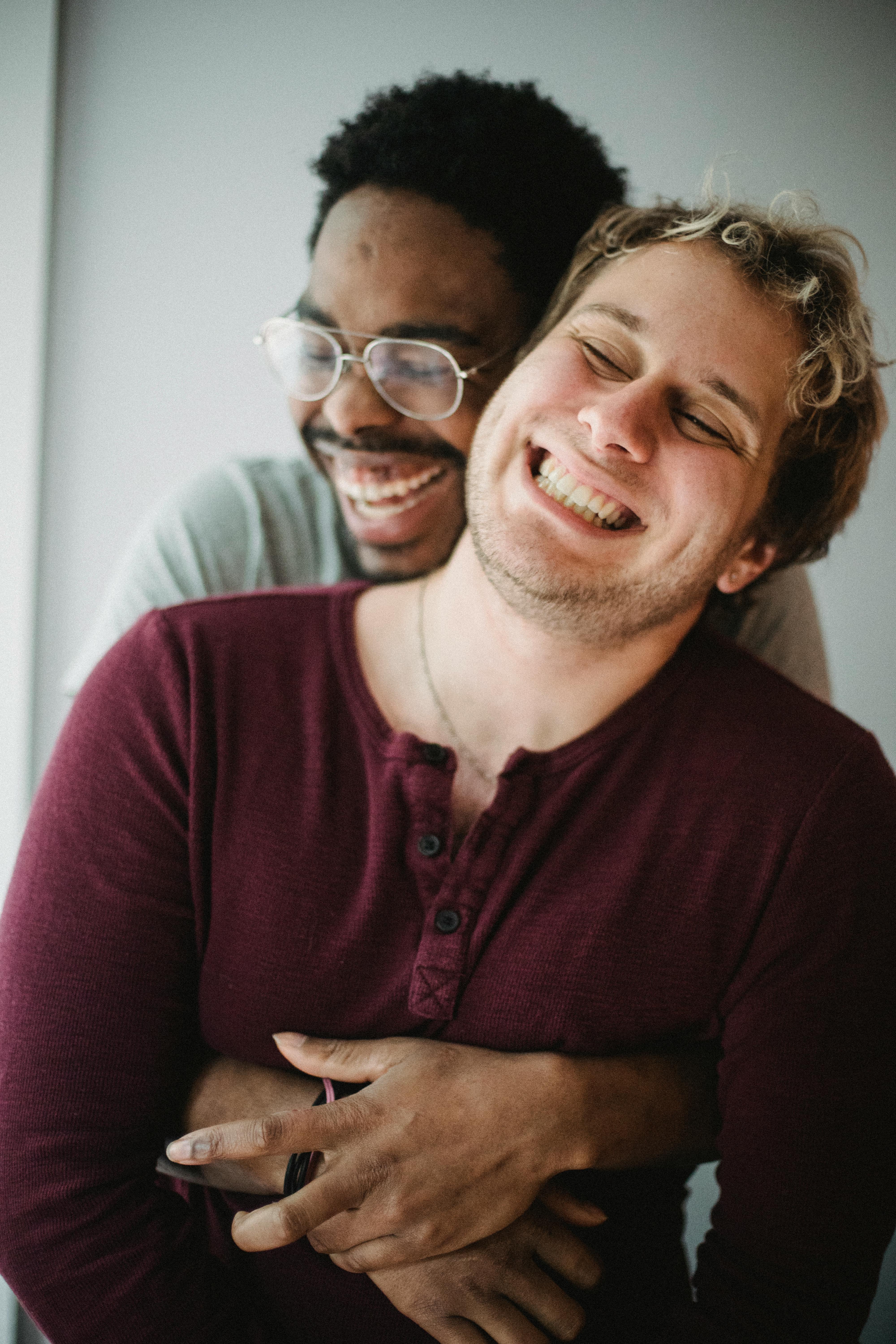 man hugging another man from behind