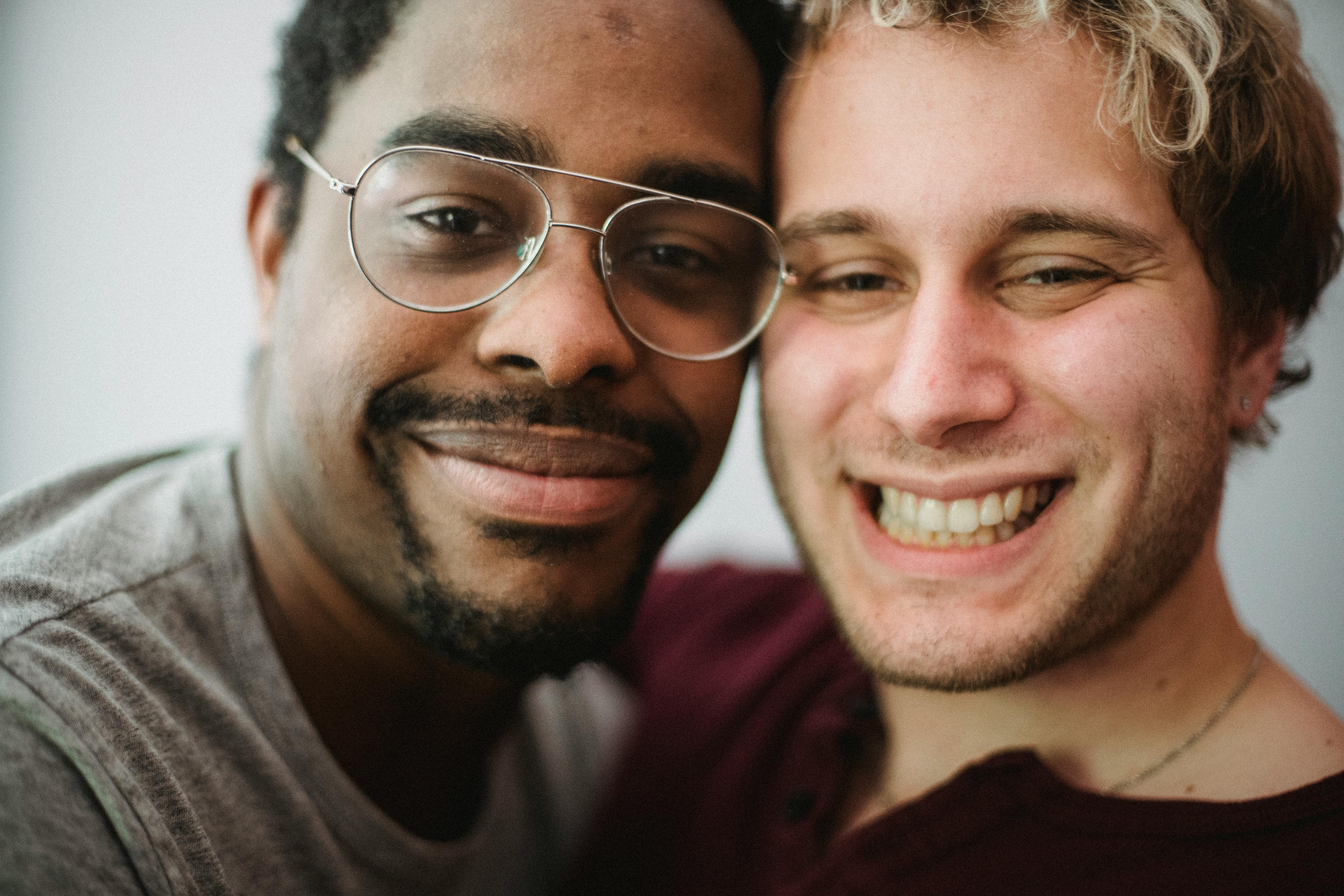 two men smiling and looking at the camera