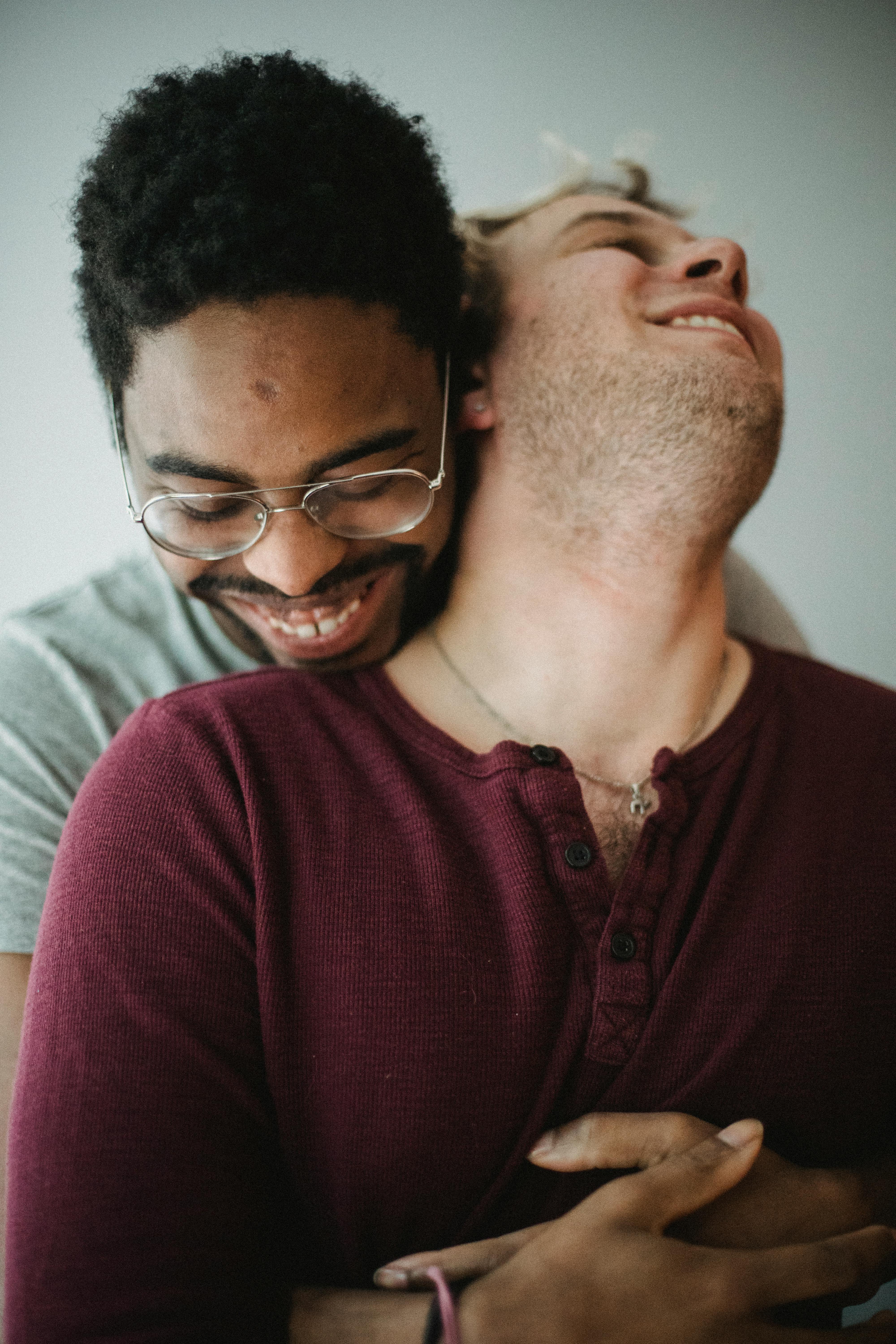 two happy men being affectionate