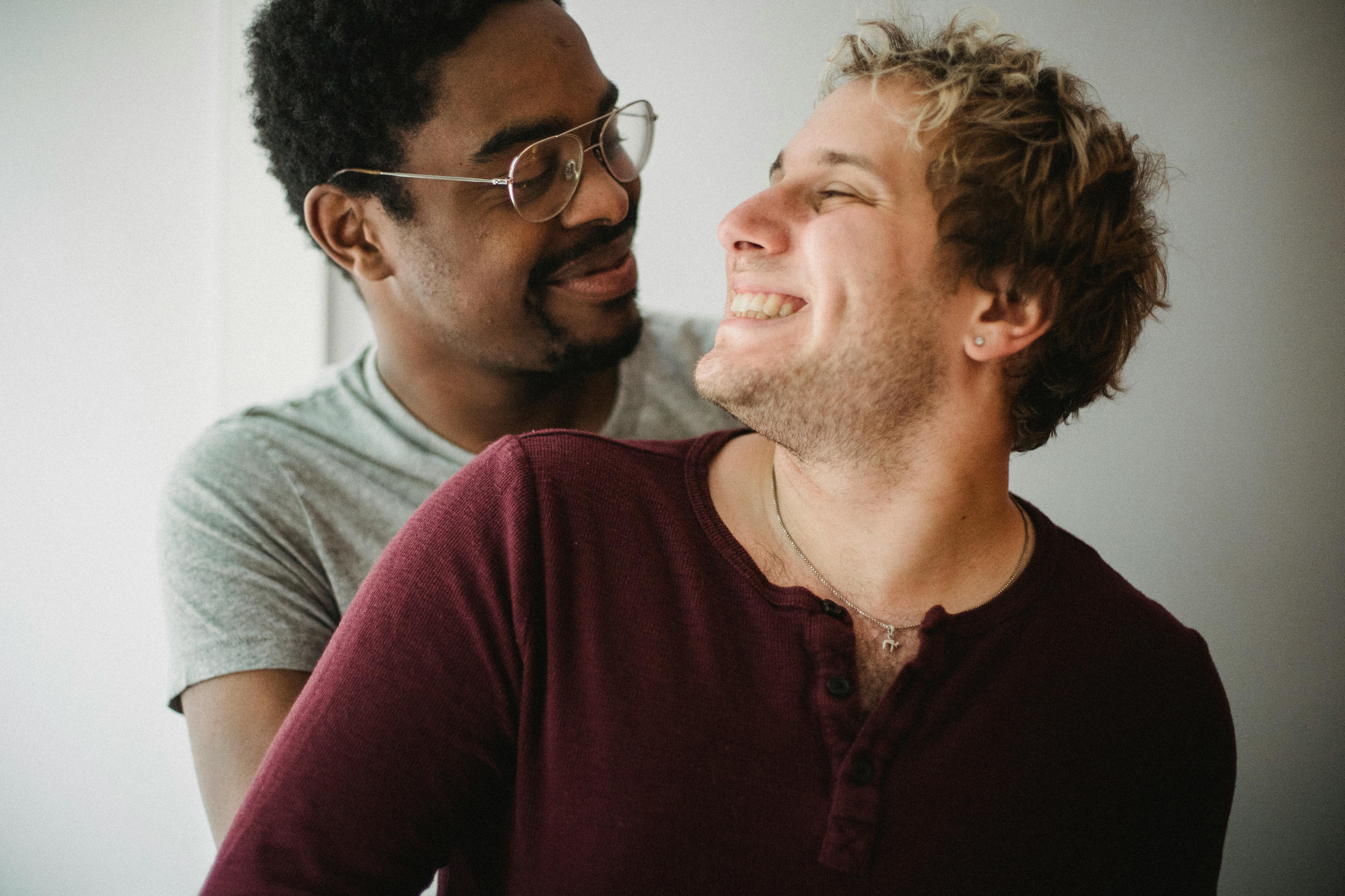 two men looking at each other and smiling