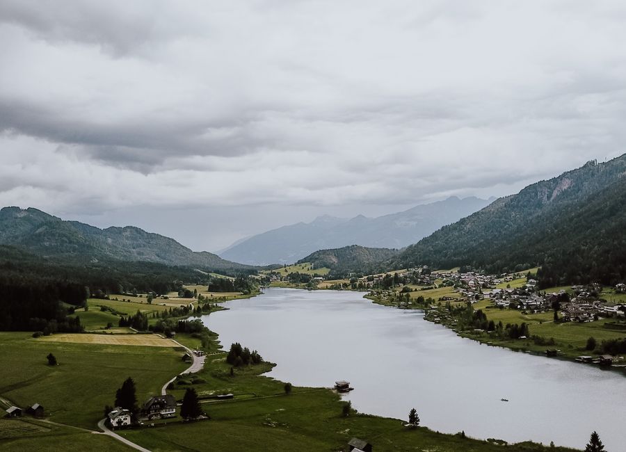 Stunning aerial view of Weißensee lake and surrounding landscape in Carinthia, Austria.