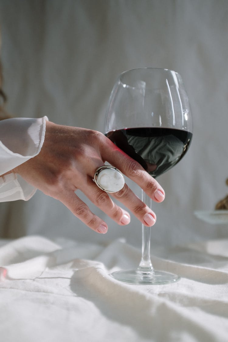 Person Holding Clear Wine Glass