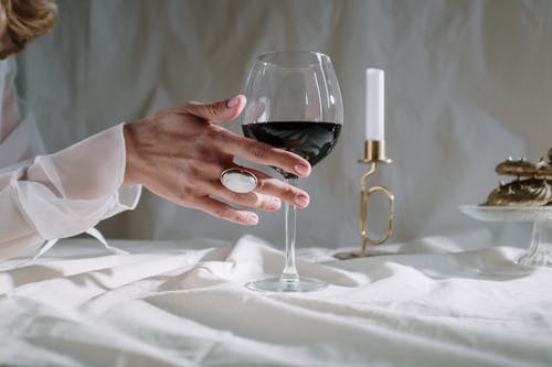 Person Holding Clear Wine Glass