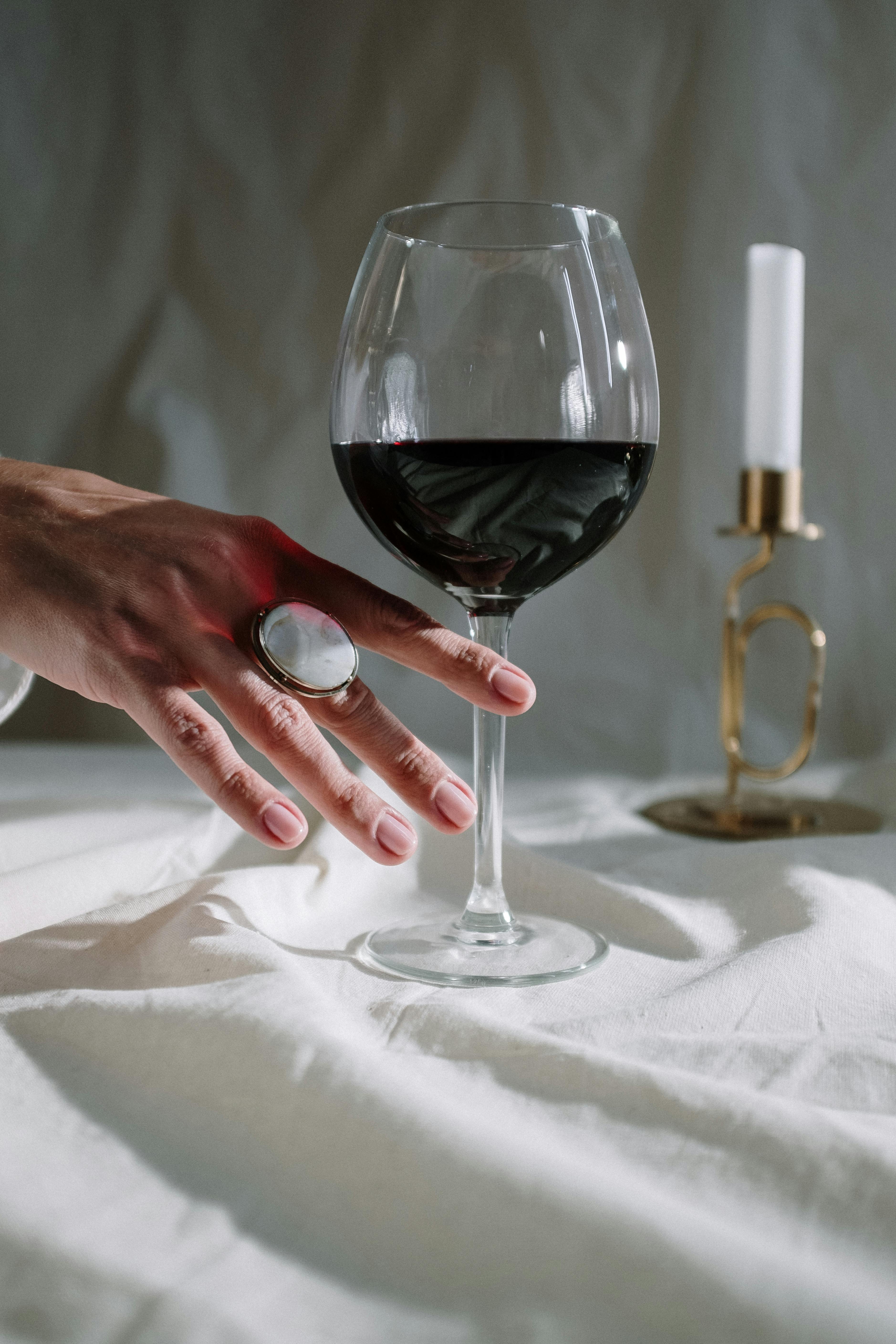 Person Holding Clear Wine Glass With Red Wine · Free Stock Photo