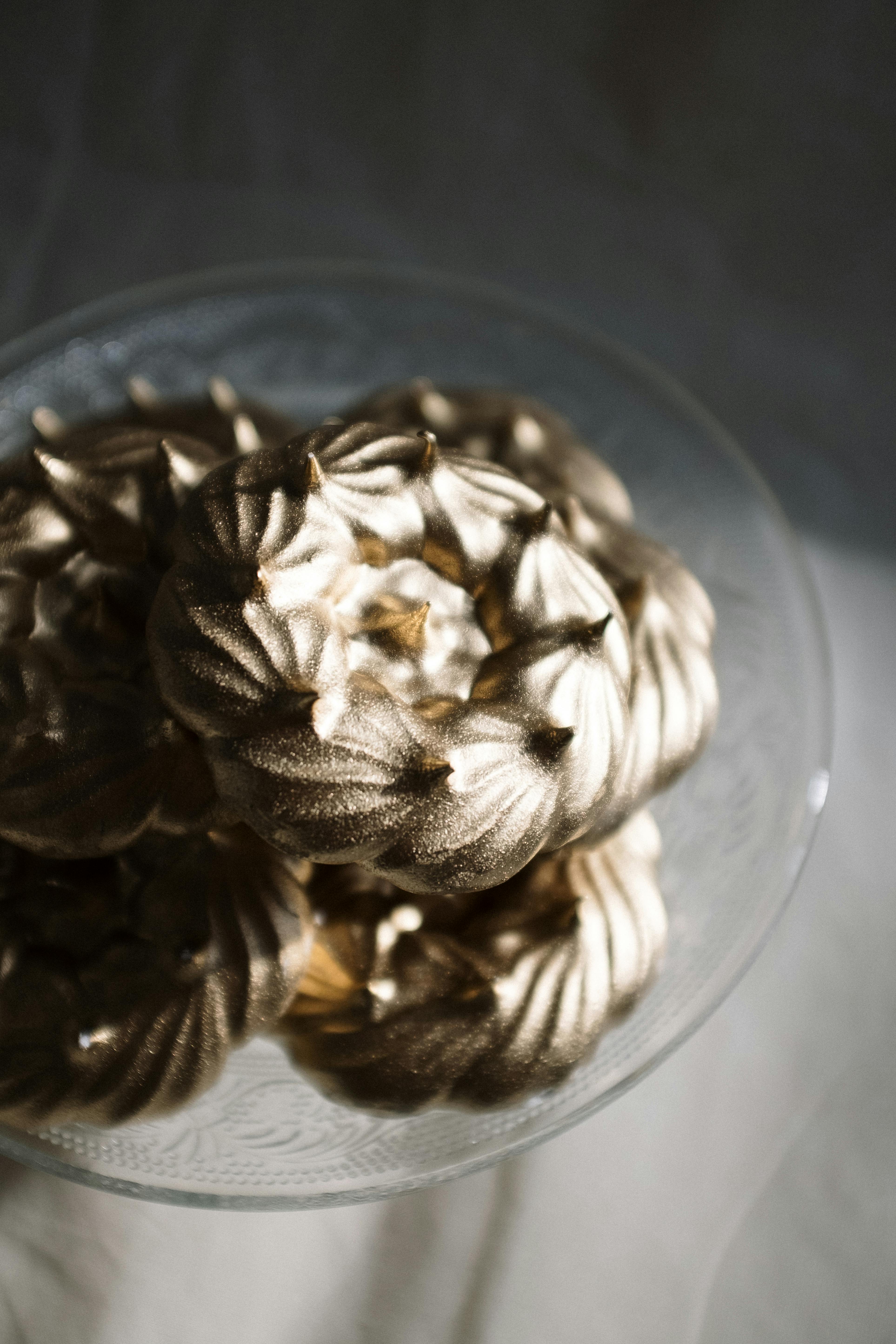 brown pine cone on clear glass bowl