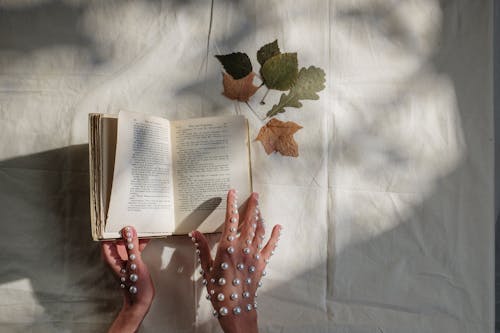 Free Person Holding White Book Page Stock Photo