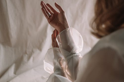 Person Holding Clear Glass Heart Shaped Ornament