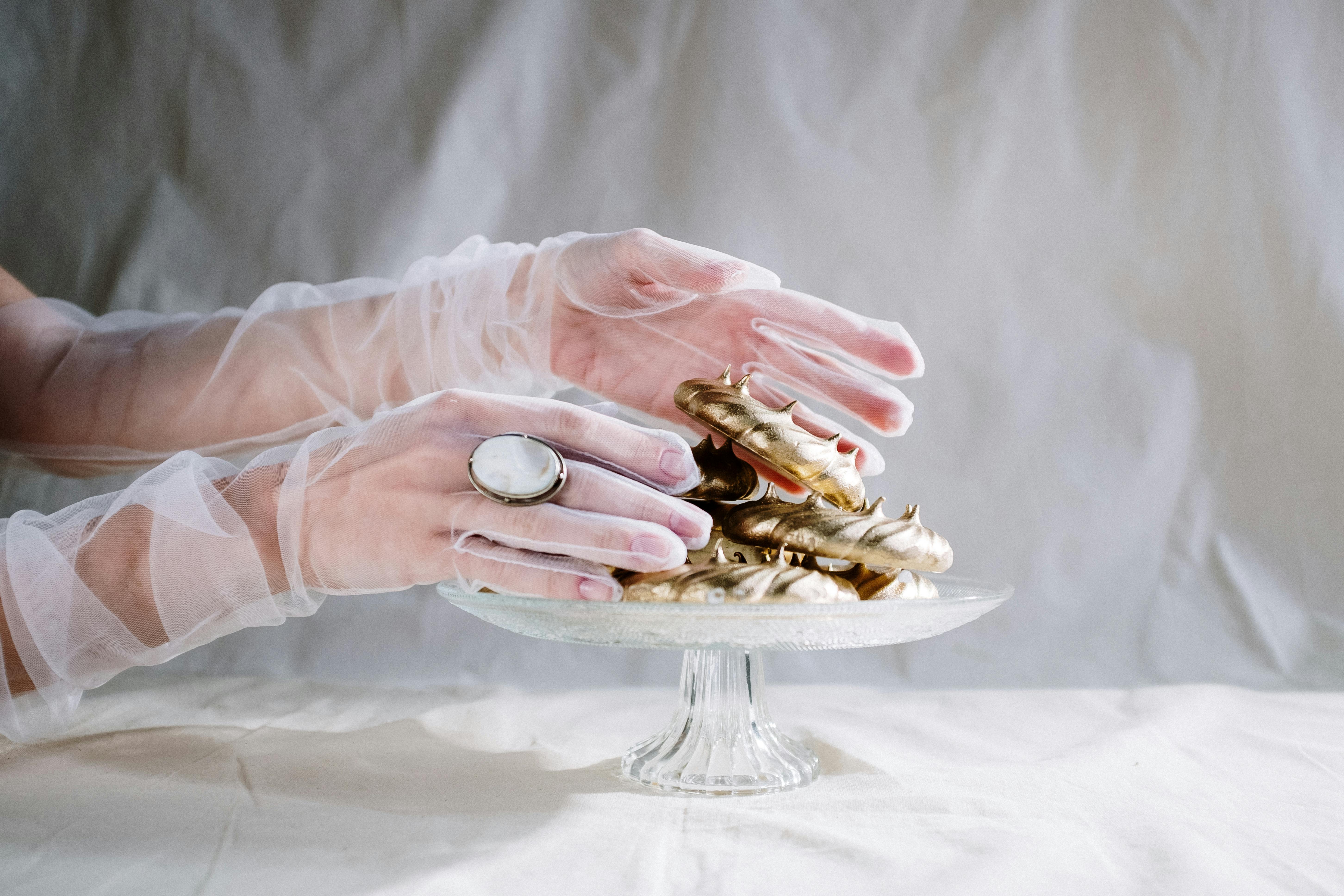 person holding gold and silver round coins