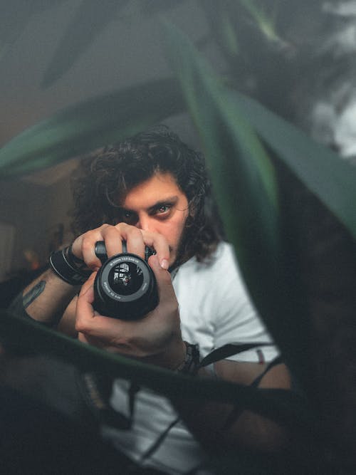 Man in White Shirt Holding Camera