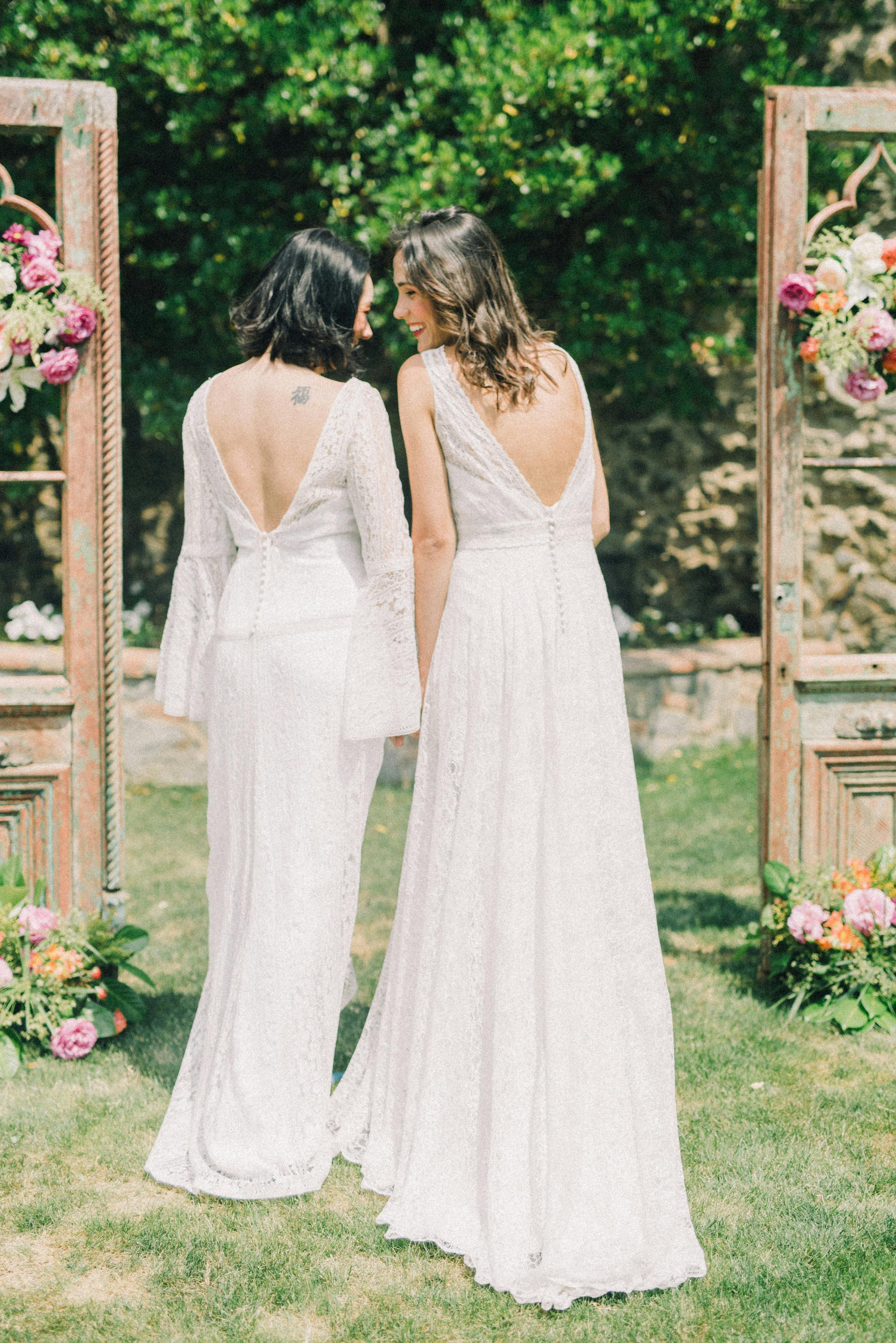 photo of women in white wedding dress standing on grass