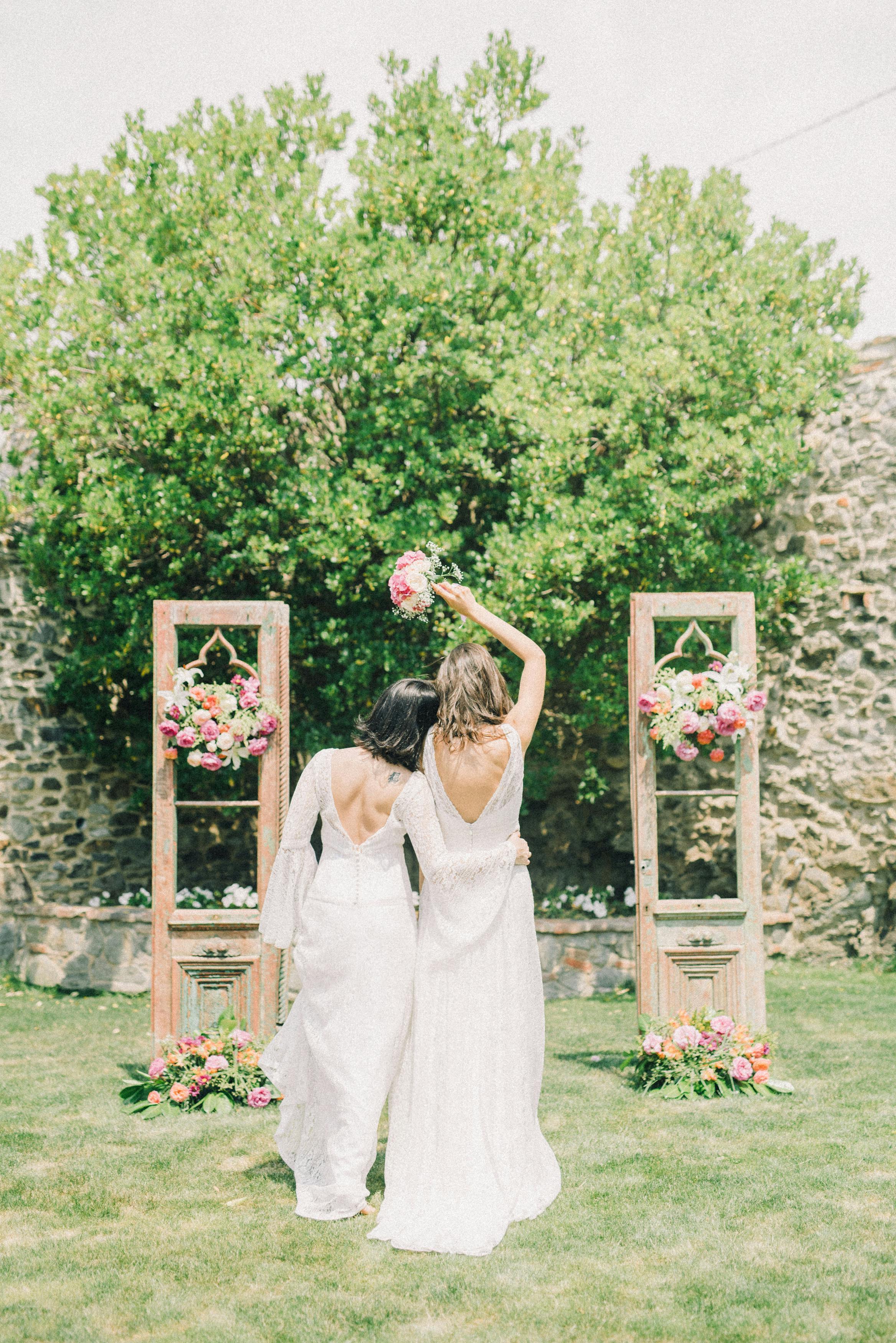 photo of women in white wedding dress standing on grass