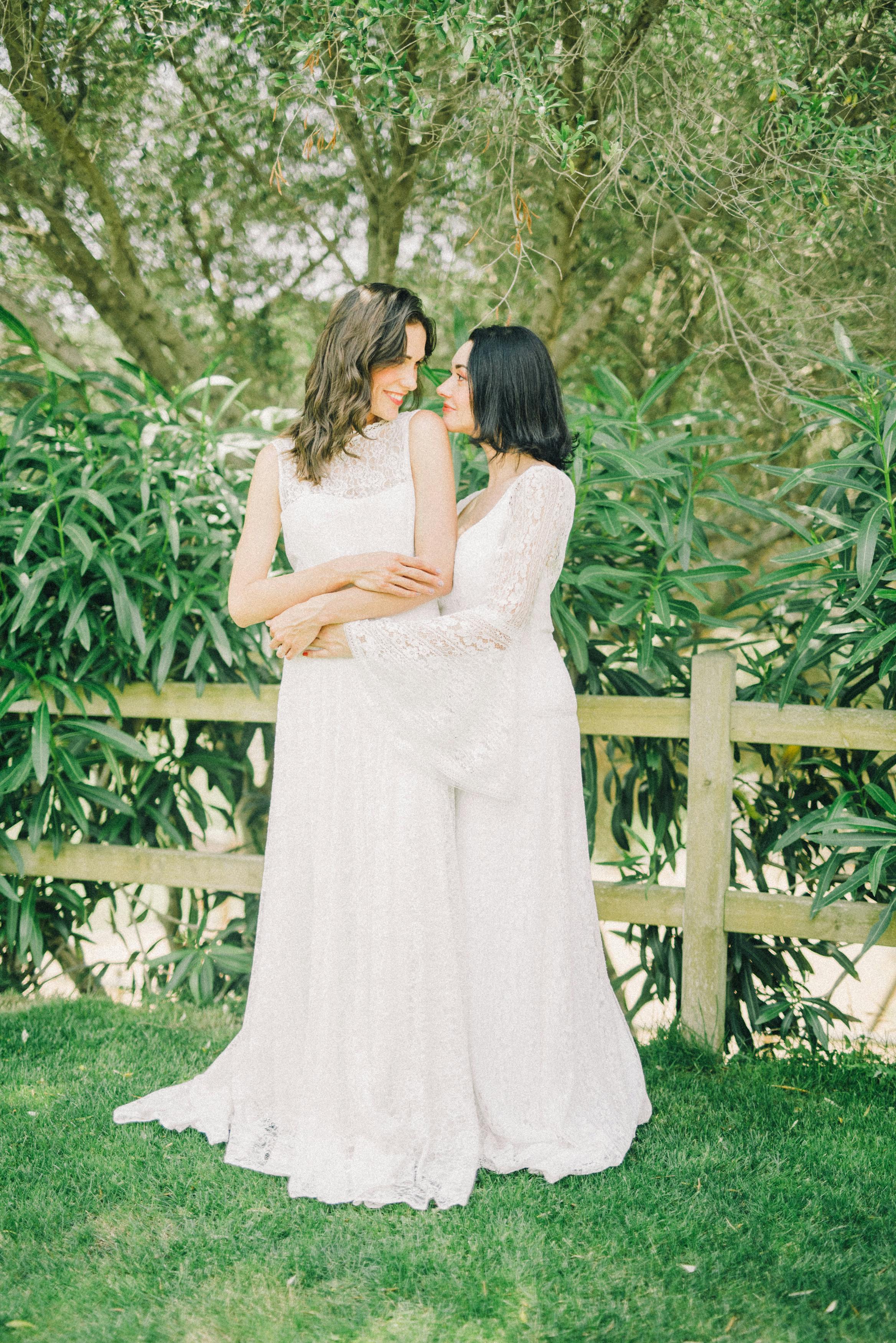 photo of women in white wedding dress looking at each other