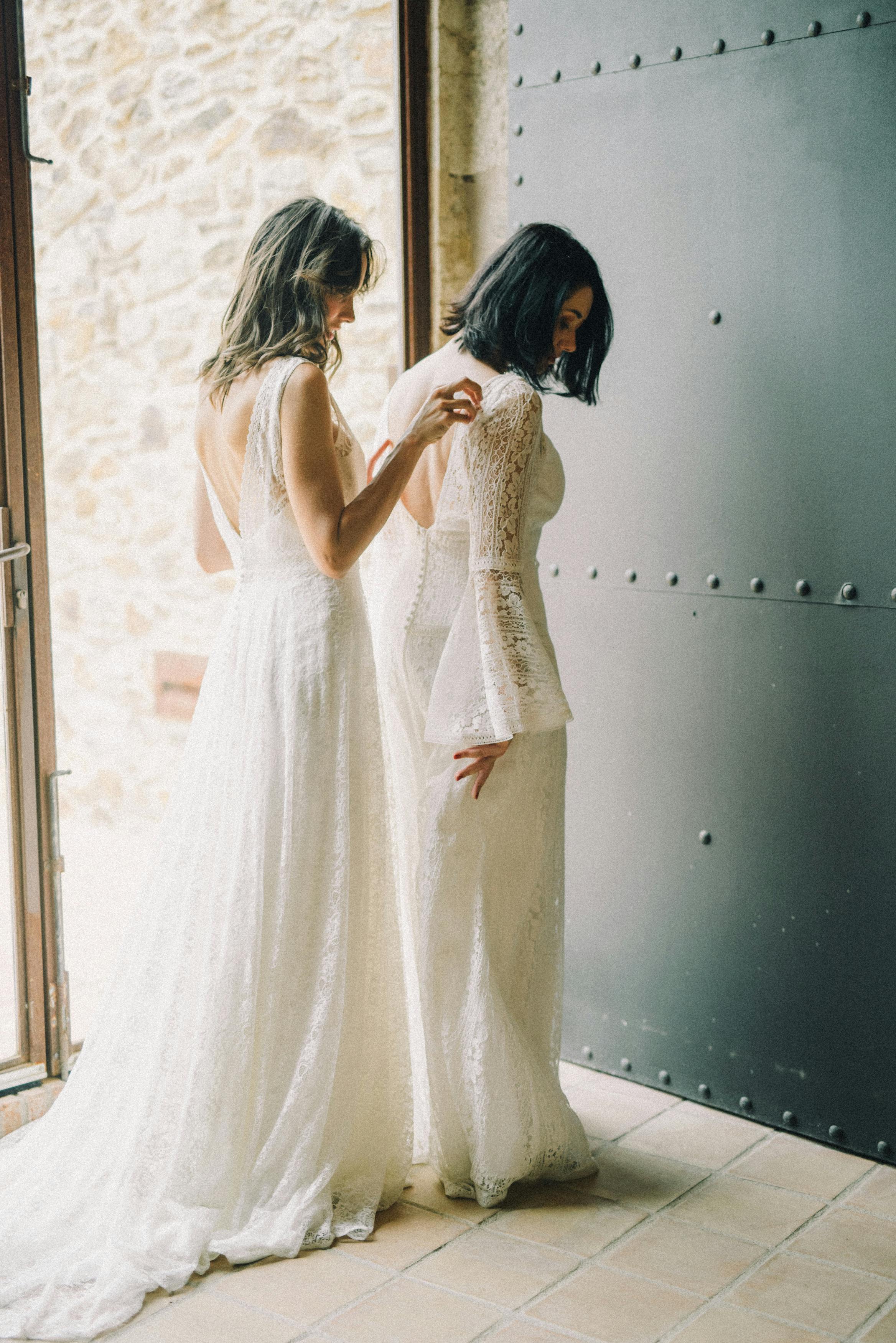 women in white gown standing at the door