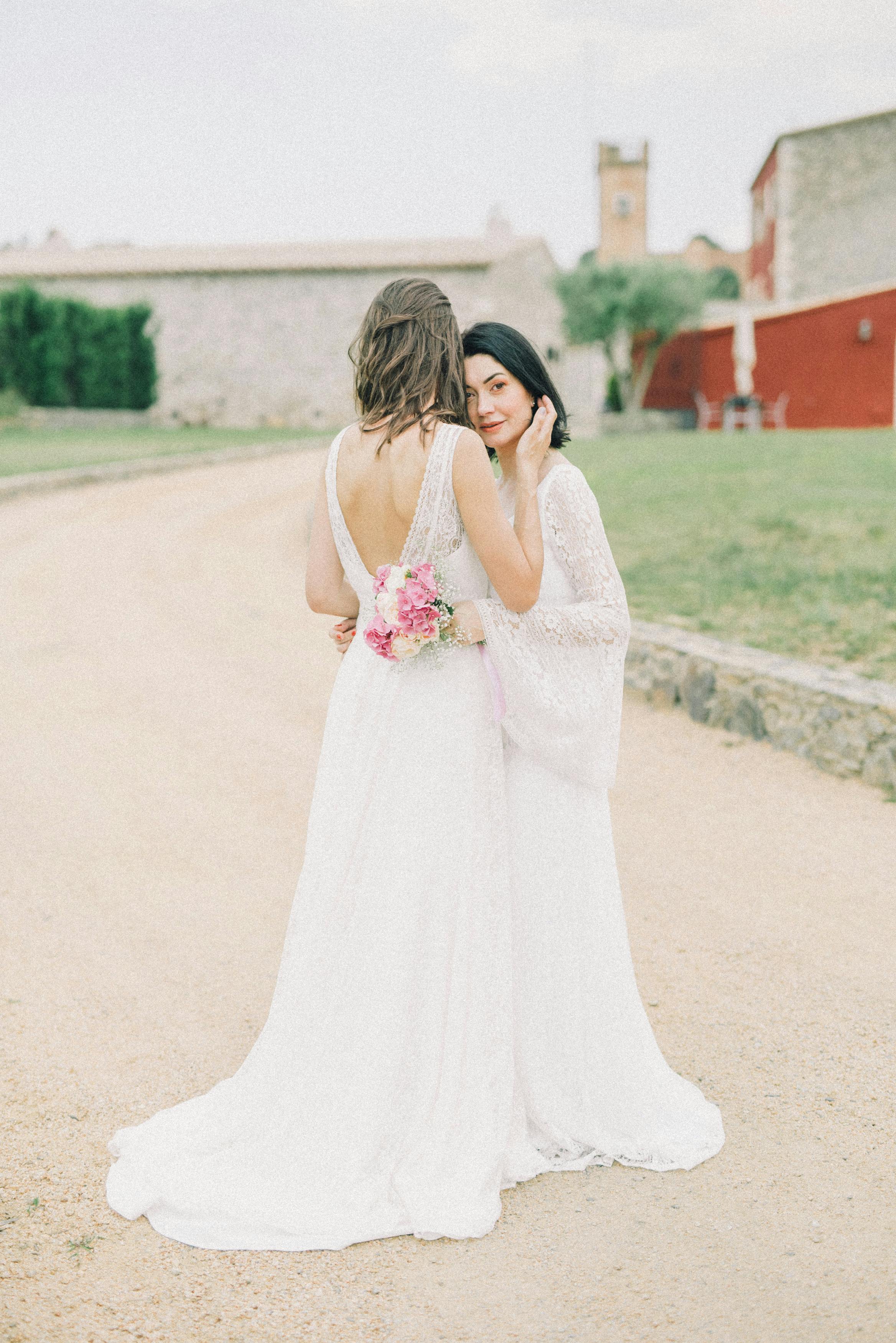 Photo of Women in White Wedding Dress Walking on Grass · Free Stock Photo