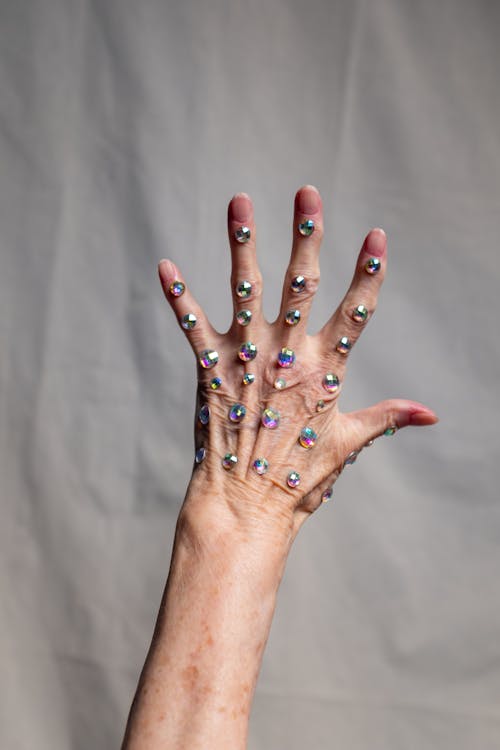Person With Blue Glitter on Left Hand