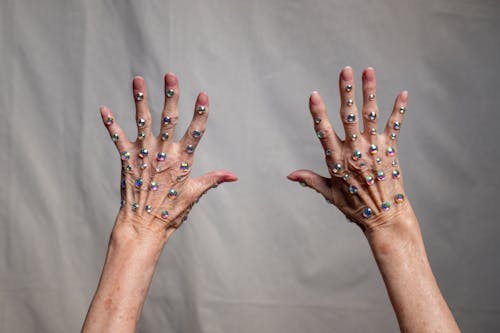Person With Blue Manicure on White Textile