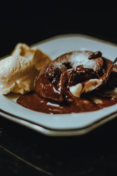 A mouthwatering close-up of a rich chocolate lava cake paired with creamy vanilla ice cream.