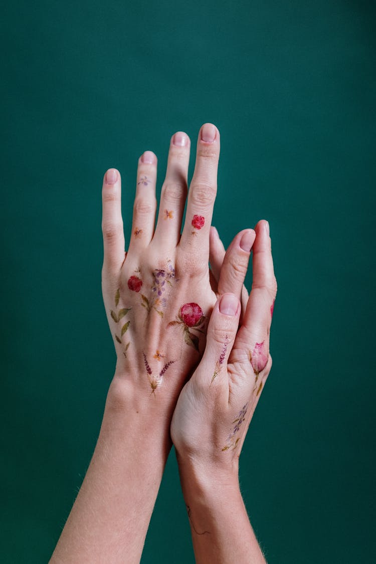 Person With Flower Temporary Tattoo On Her Hands