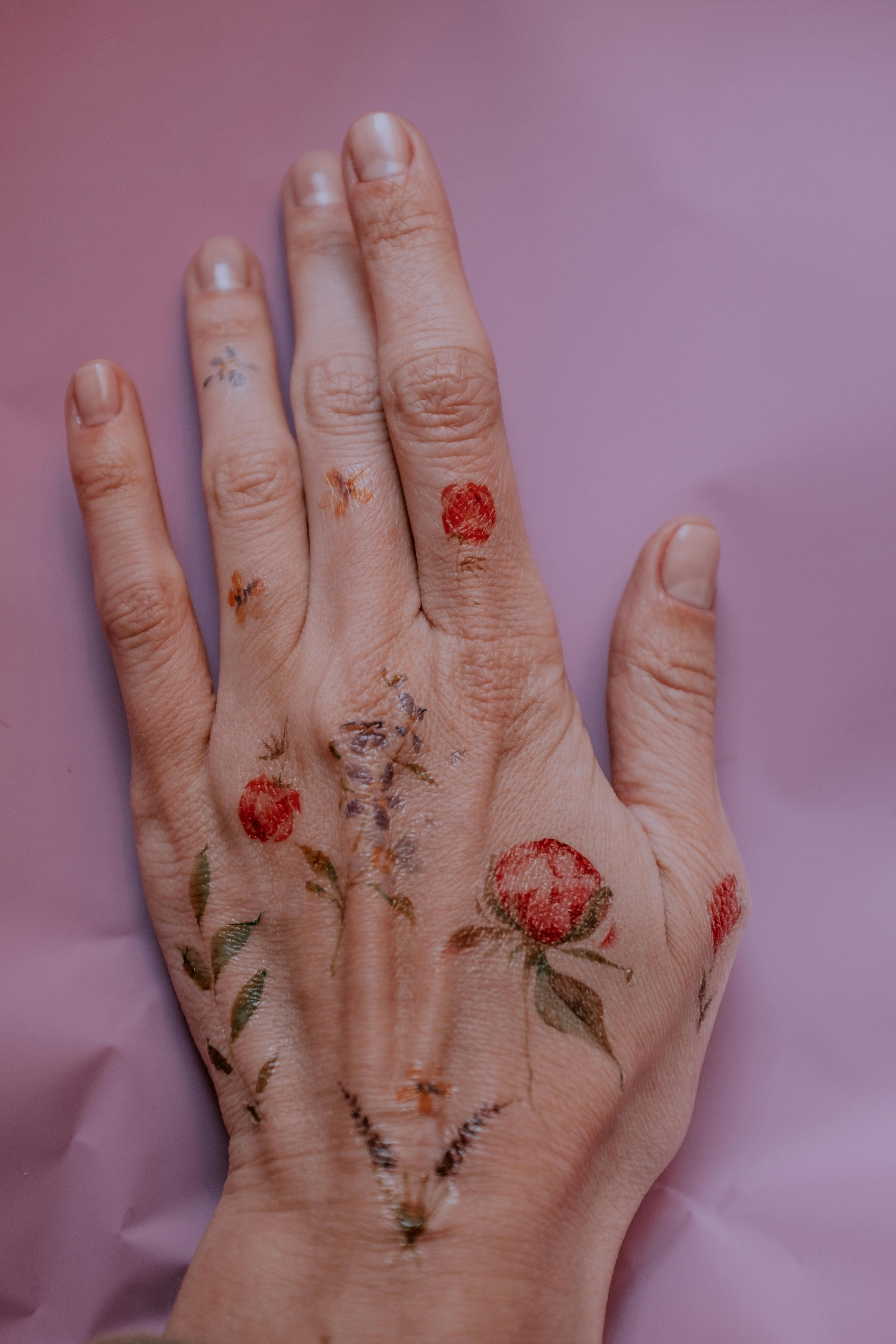 Beautiful flower tattoos on the left hand and wrist  Tattoogridnet