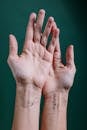 Photo of Person's Hand With Tattoo on Wrist
