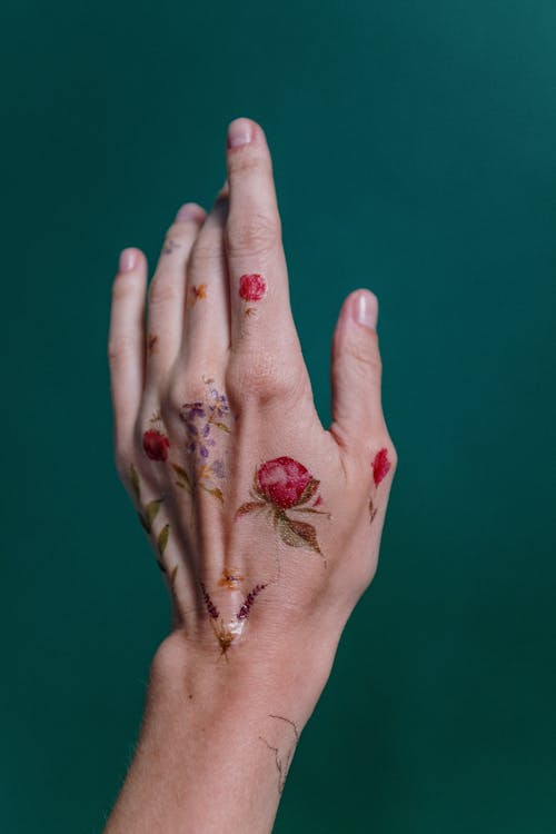 Free Photo of Flower Tattoos on Person's Left Hand Stock Photo