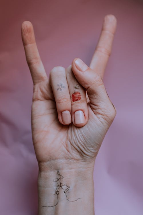 Person's Hand Doing Rock and Roll Hand Sign