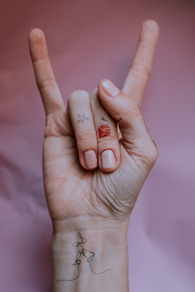 Person's Hand Doing Rock And Roll Hand Sign