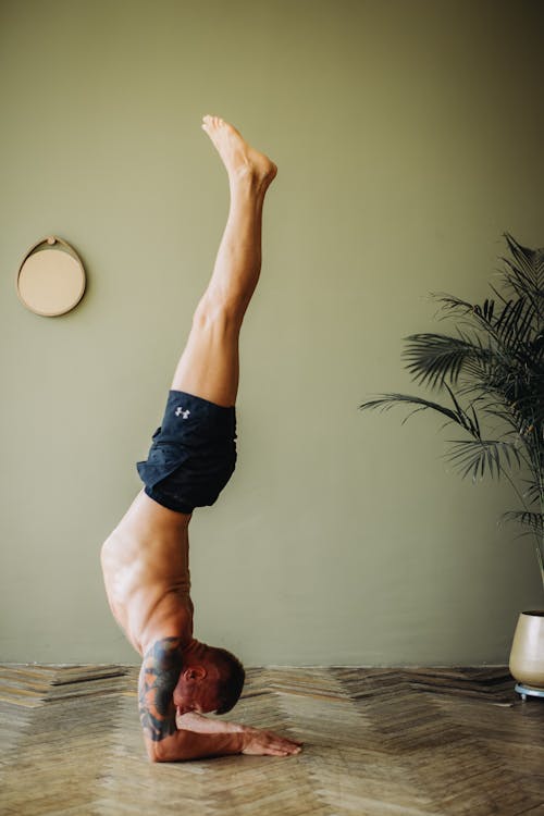 Shirtless Man Doing Handstand · Free Stock Photo