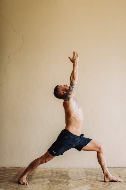 Man with Arm Tattoo Doing Yoga · Free Stock Photo