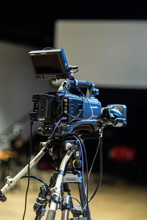 Professional film camera on tripod in studio