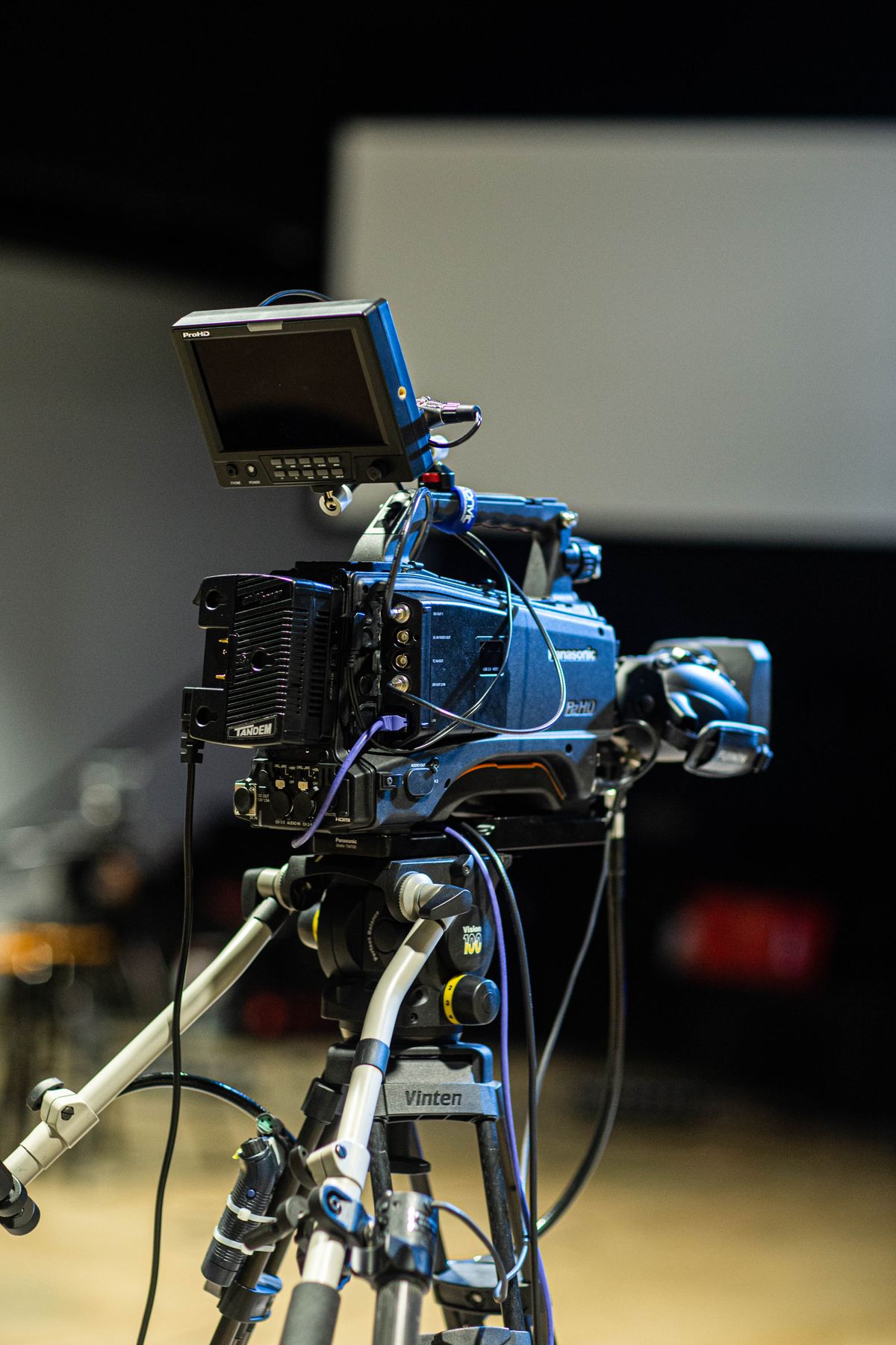 Professional video camera on a tripod in a studio, representing project-based billing in media and creative ERP software